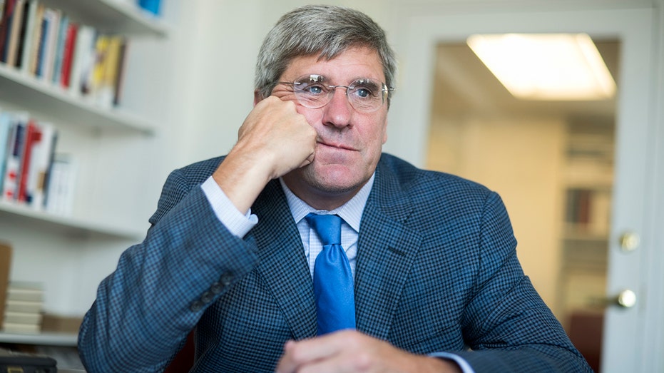 Economist Steve Moore sits at a table during an interview