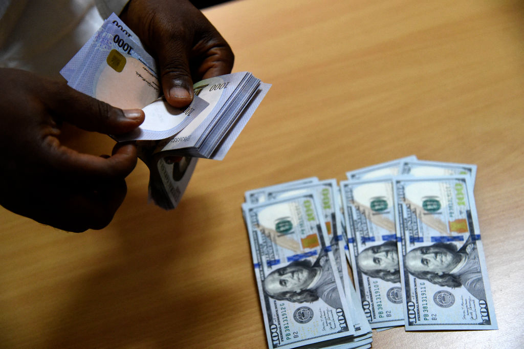 A man exchanges Nigeria's currency Naira for US dollars in Lagos, Nigeria, on April 19, 2021. - Nigeria's economy was already struggling with a fall in the price of oil, Nigeria's major export, and a weak local naira currency, before the global pandemic struck. Now Nigeria's inflation has soared to a four-year high of more than 18 percent in March 2021, with food prices up 22.9 percent, according to the National Bureau of Statistics. (Photo by PIUS UTOMI EKPEI / AFP) (Photo by PIUS UTOMI EKPEI/AFP via Getty Images)