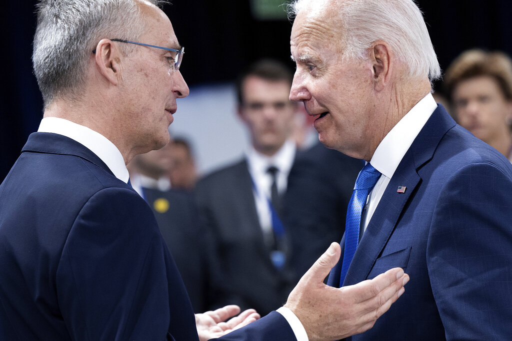 NATO Secretary General Jens Stoltenberg, left, and U.S. President Joe Biden speak before attending a round table meeting at a NATO summit in Madrid, Spain on Wednesday, June 29, 2022. North Atlantic Treaty Organization heads of state will meet for a NATO summit in Madrid from Tuesday through Thursday. (Brendan Smialowski/Pool Photo via AP)