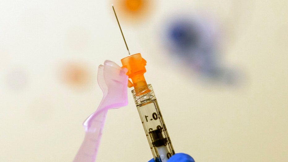 A nurse prepares a kids' Pfizer vaccine shot