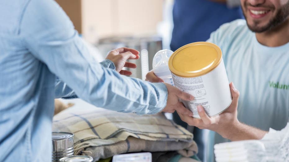 Man holds baby formula can