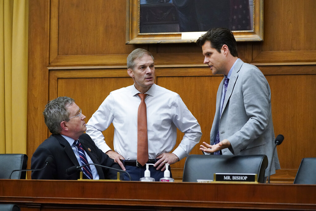 From left, Rep. Thomas Massie, R-Ky., Rep. Jim Jordan, R-Ohio, and Rep. Matt Gaetz, R-Fla., confer as the House Judiciary Committee holds an emergency meeting to advance a series of Democratic gun control measures, called the Protecting Our Kids Act, in response to mass shootings in Texas and New York, at the Capitol in Washington, Thursday, June 2, 2022. (AP Photo/J. Scott Applewhite)