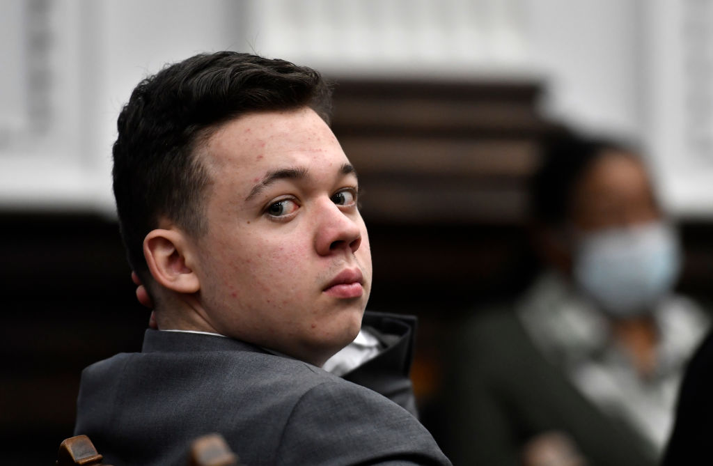 KENOSHA, WISCONSIN - NOVEMBER 12: Kyle Rtttenhouse looks back as attorneys argue about the charges that will be presented to the jury during proceedings at the Kenosha County Courthouse on November 12, 2021 in Kenosha, Wisconsin. Rittenhouse is accused of shooting three demonstrators, killing two of them, during a night of unrest that erupted in Kenosha after a police officer shot Jacob Blake seven times in the back while being arrested in August 2020. Rittenhouse, from Antioch, Illinois, was 17 at the time of the shooting and armed with an assault rifle. He faces counts of felony homicide and felony attempted homicide. (Photo by Sean Krajacic-Pool/Getty Images)
