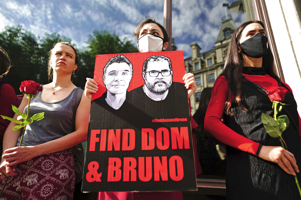 People take part in a vigil outside the Brazilian Embassy for Dom Phillips and Bruno Araujo Pereira, a British journalist and an Indigenous affairs official who are missing in the Amazon, in London, Thursday, June 9, 2022. Brazilian authorities began using helicopters Wednesday to search a remote area of the Amazon rainforest for a British journalist and Indigenous official missing more than three days. (Victoria Jones/PA via AP)