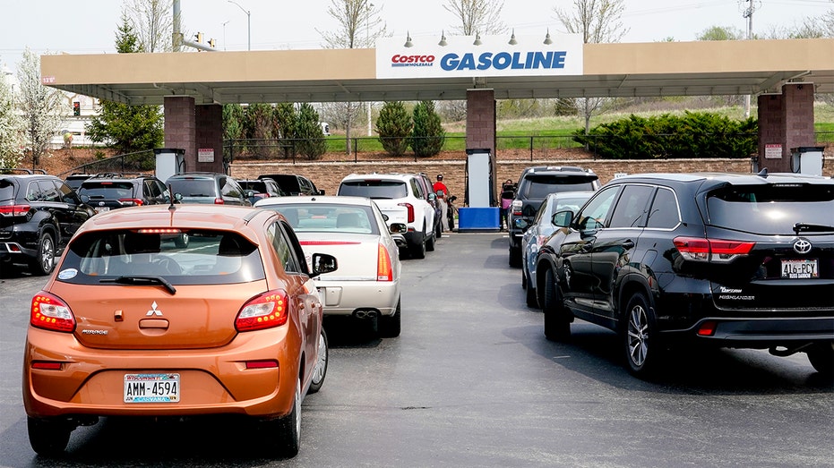Cars line up for gas outside a Costco Wednesday, May 11, 2022, in Pewaukee, Wis. The Costco offered gas at less than $4 a gallon, some of the cheapest in the area. (AP Photo/Morry Gash)