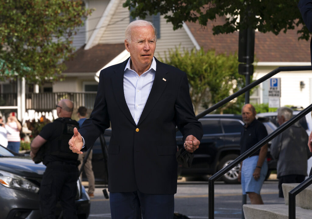 President Joe Biden reacts when asked how he was feeling as he leaves St. Edmund Roman Catholic Church in Rehoboth Beach, Del., after attending a Mass, Saturday, June 18, 2022. Bystanders cheered as he was asked how he was feeling. He smiled, and took three hops forward, making a jump-rope motion with his hands. (AP Photo/Manuel Balce Ceneta)