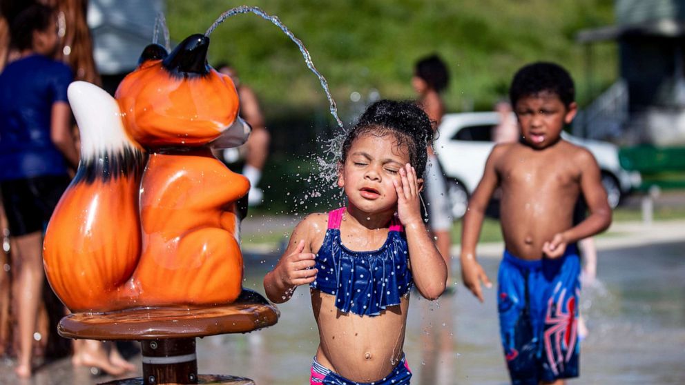 PHOTO: Three-year-old Mylayna Briscoe plays at the St. Cloud Commons splash pad, June 14, 2022, in Huntington, W.Va.