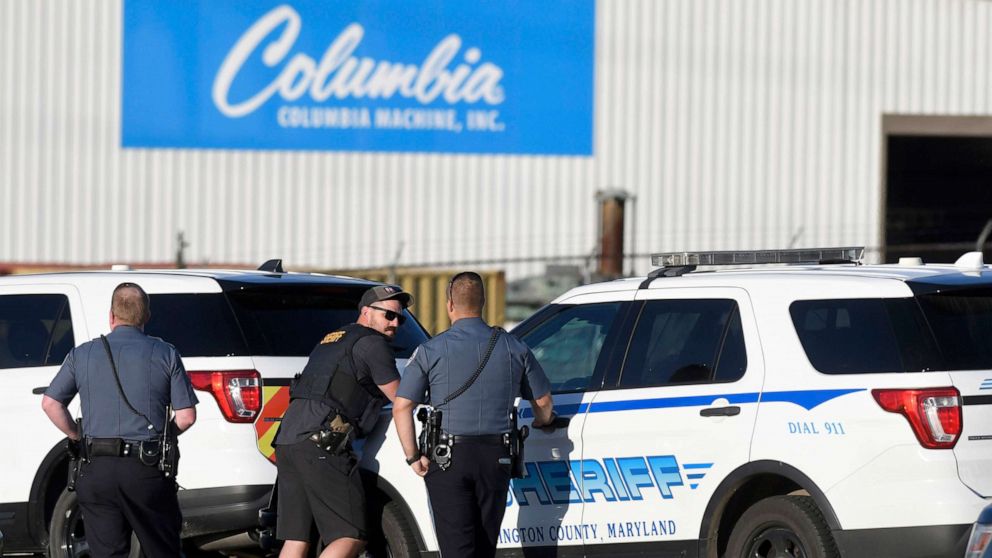 PHOTO: Police stand near where a man opened fire at a business, killing three people before the suspect and a state trooper were wounded in a shootout, according to authorities, in Smithsburg, Md., June 9, 2022.