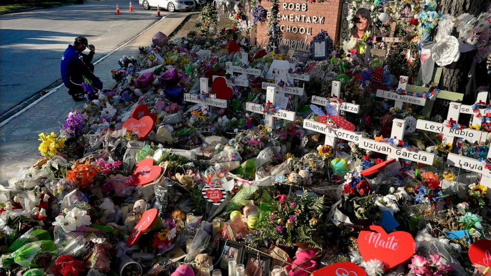 PHOTO: A man pays his respects at a memorial outside Robb Elementary School to honor the victims killed in last week's school shooting, onJune 2, 2022, in Uvalde, Texas.