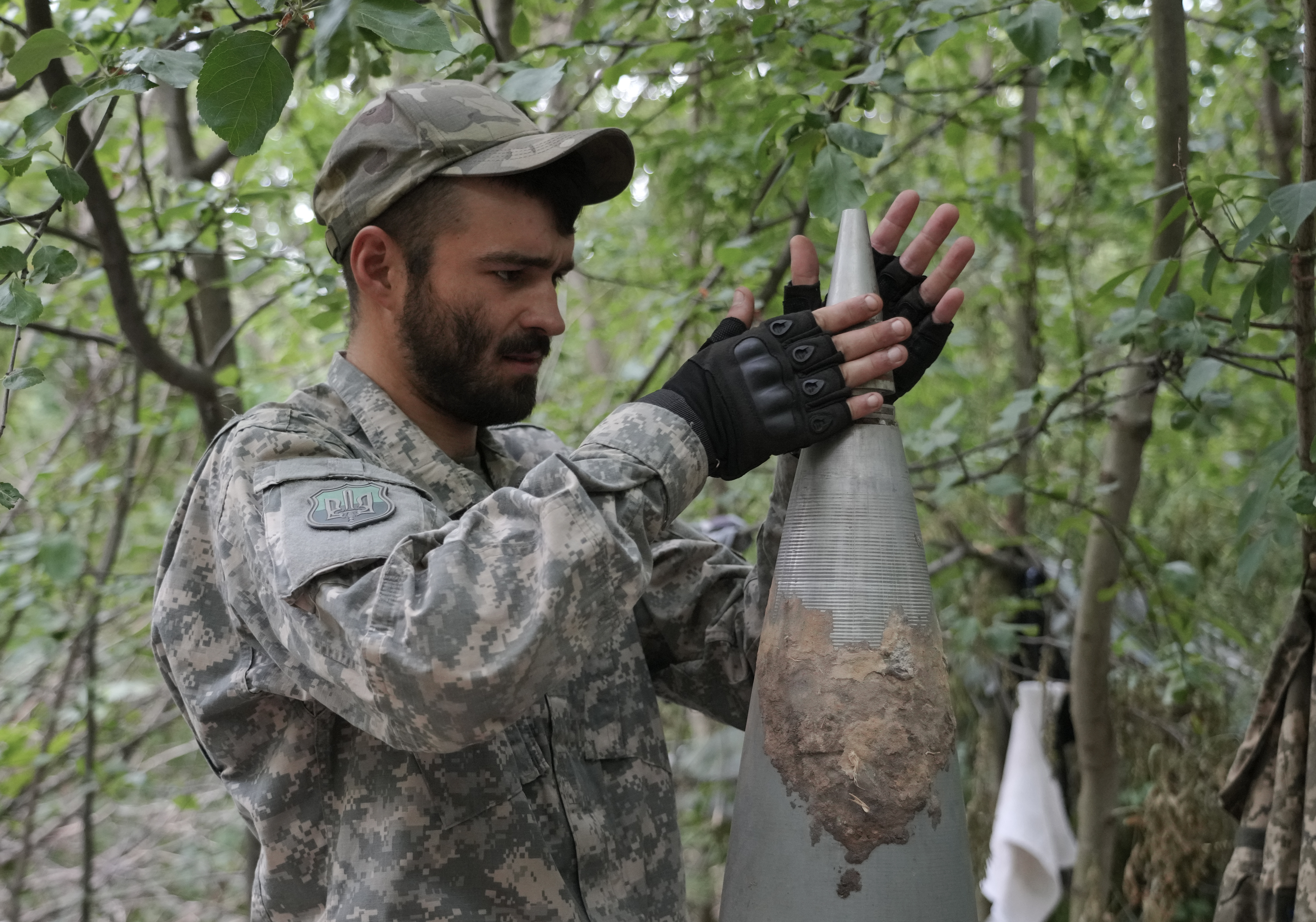 A Ukrainian soldiers removes an exploder from a Russian Smerch multiple rocket in Ukraine's war-hit eastern Donbas region Saturday, June 18, 2022. (AP Photo/Efrem Lukatsky)