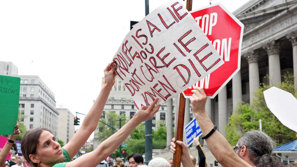 PHOTO: An abortion rights protester holds a placard in front of an anti-abortion protester during demonstrations following the leaked Supreme Court opinion suggesting the possibility of overturning Roe v. Wade, in New York, May 14, 2022.