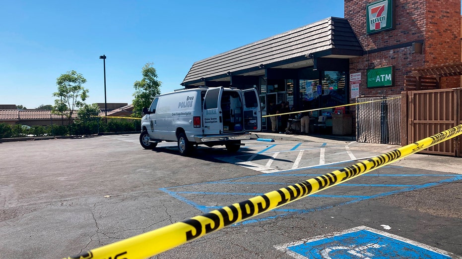 A police vehicle is seen park in front of a 7-Eleven store after a deadly shooting