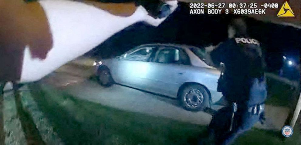 PHOTO: This image captured from a police officer's body camera and provided by the Akron Police Department on July 3, 2022, shows police surrounding the vehicle of 25 year old Jayland Walker during a traffic stop in Akron, Ohio, on June 27, 2022.