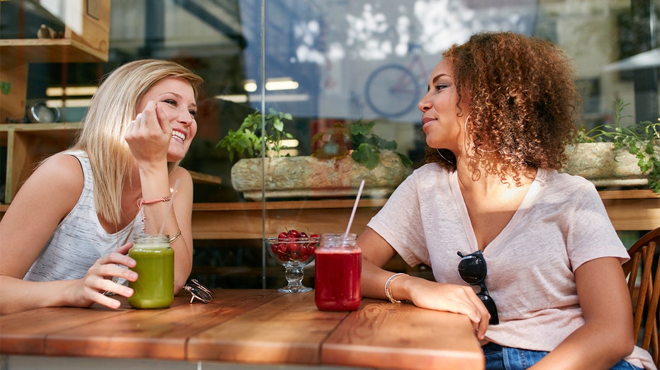 two females having a drink