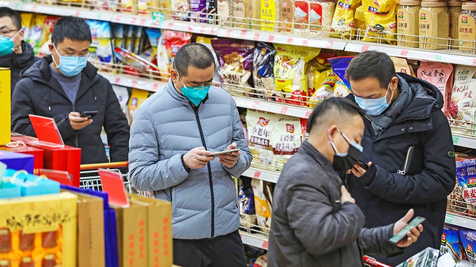 Shoppers in China wear masks during the COVID-19 pandemic