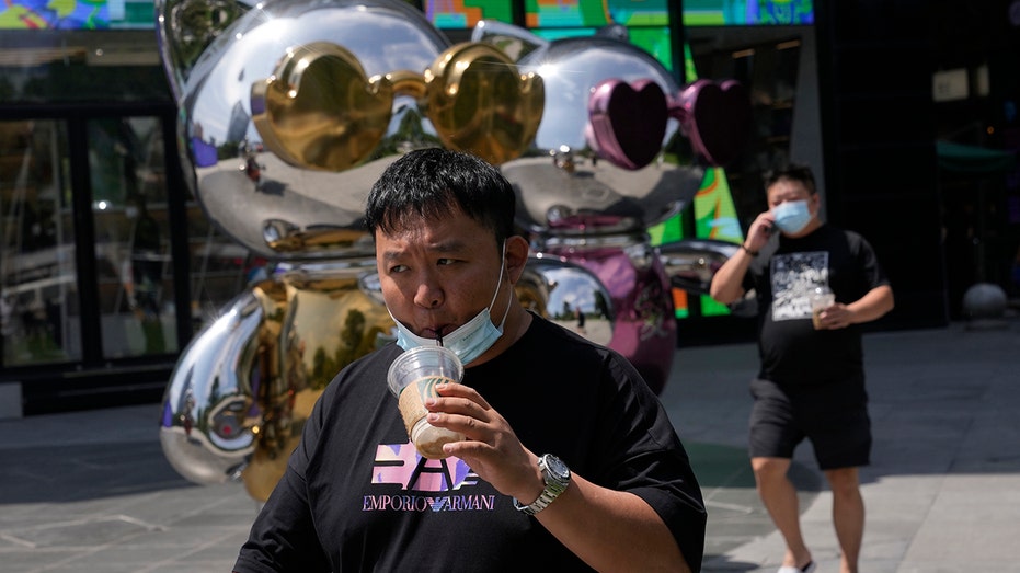 Man walks near a mall in China