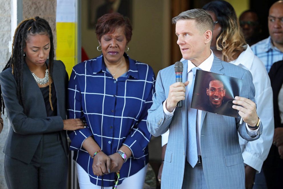 PHOTO: Attorney Bobby DiCello, right, holds up a photograph of Jayland Walker as Paige White, left, comforts Jayland's mother Pamela Walker during a press conference at St. Ashworth Temple on June 30, 2022, in Akron, Ohio.