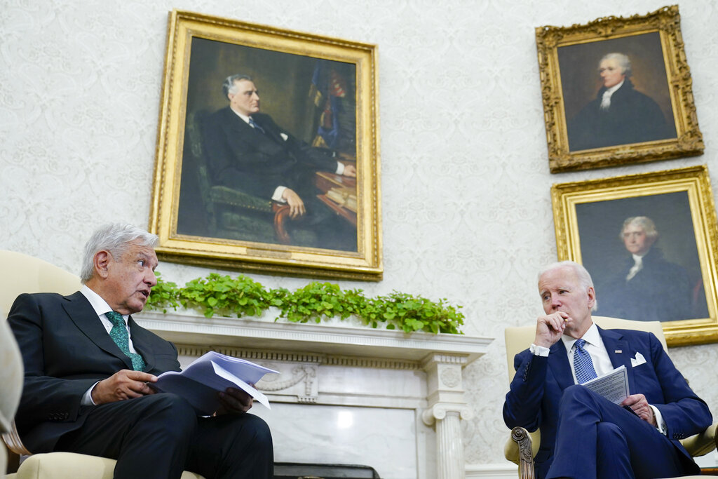 President Joe Biden listens as Mexican President Andrés Manuel López Obrador speaks in the Oval Office of the White House in Washington, Tuesday, July 12, 2022. (AP Photo/Susan Walsh)