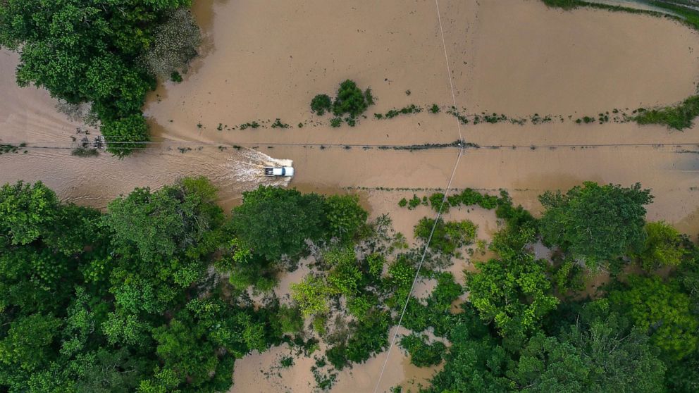 PHOTO: A truck drives along flooded Wolverine Road in Breathitt County, Ky., July 28, 2022, after heavy rains caused flash flooding and mudslides in parts of central Appalachia.