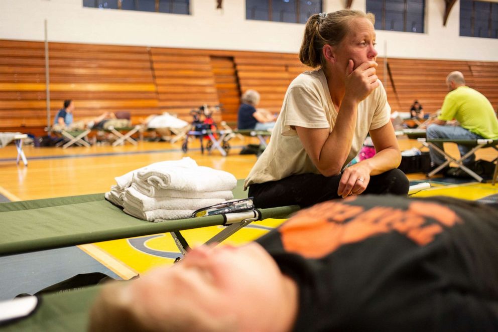 PHOTO: April Stivers, 38, of Lost Creek, Kentucky, takes a moment to herself in the Hazard Community & Technical College, where survivors of the major flooding in Eastern Kentucky are being taken for shelter on July 28, 2022 in Breathitt County, Ky. 
