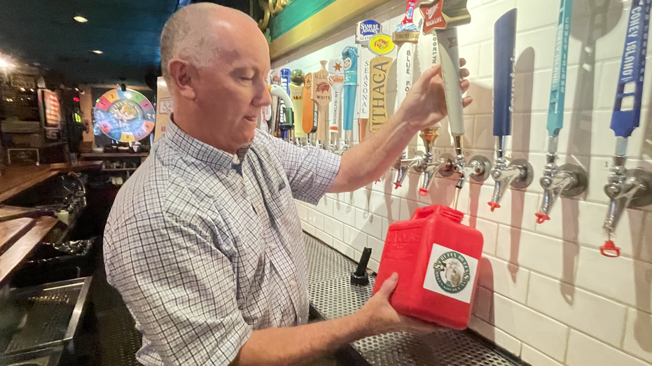 Pat Hughes of Scruffy Duffy's filling.a gallon gas can with beer