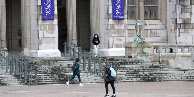 Students at the University of Washington are shown on campus in Seattle in March of 2020. 