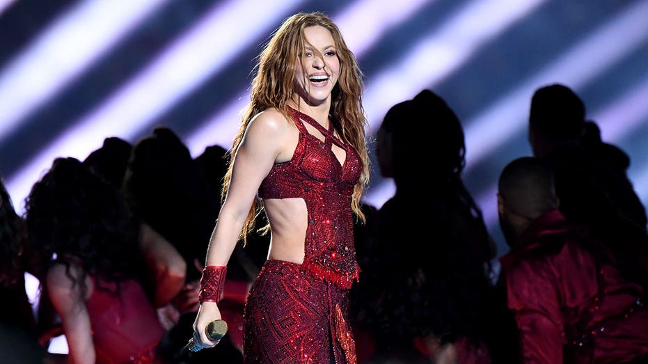 Shakira wearing red sparkly dress on stage