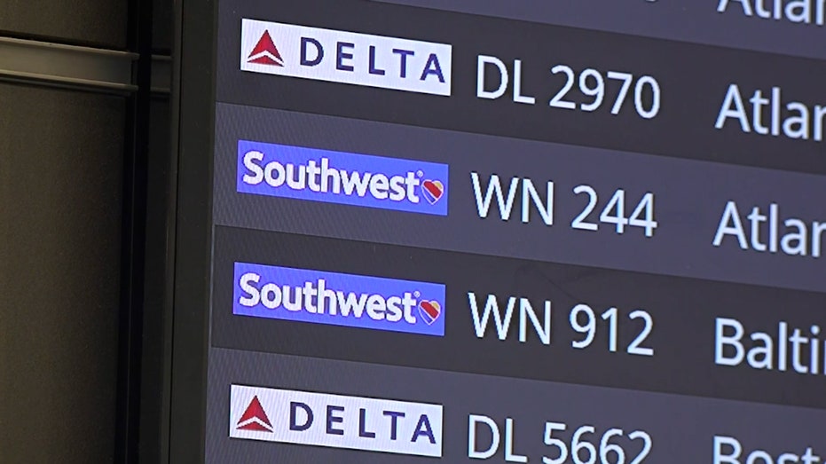 A photo of a flight board showing several Southwest and Delta flights
