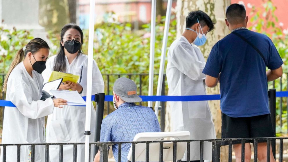 PHOTO: Healthcare workers with New York City Department of Health and Mental Hygiene help people register for the monkeypox vaccine at one of the City's vaccination sites, on July 26, 2022, in New York.