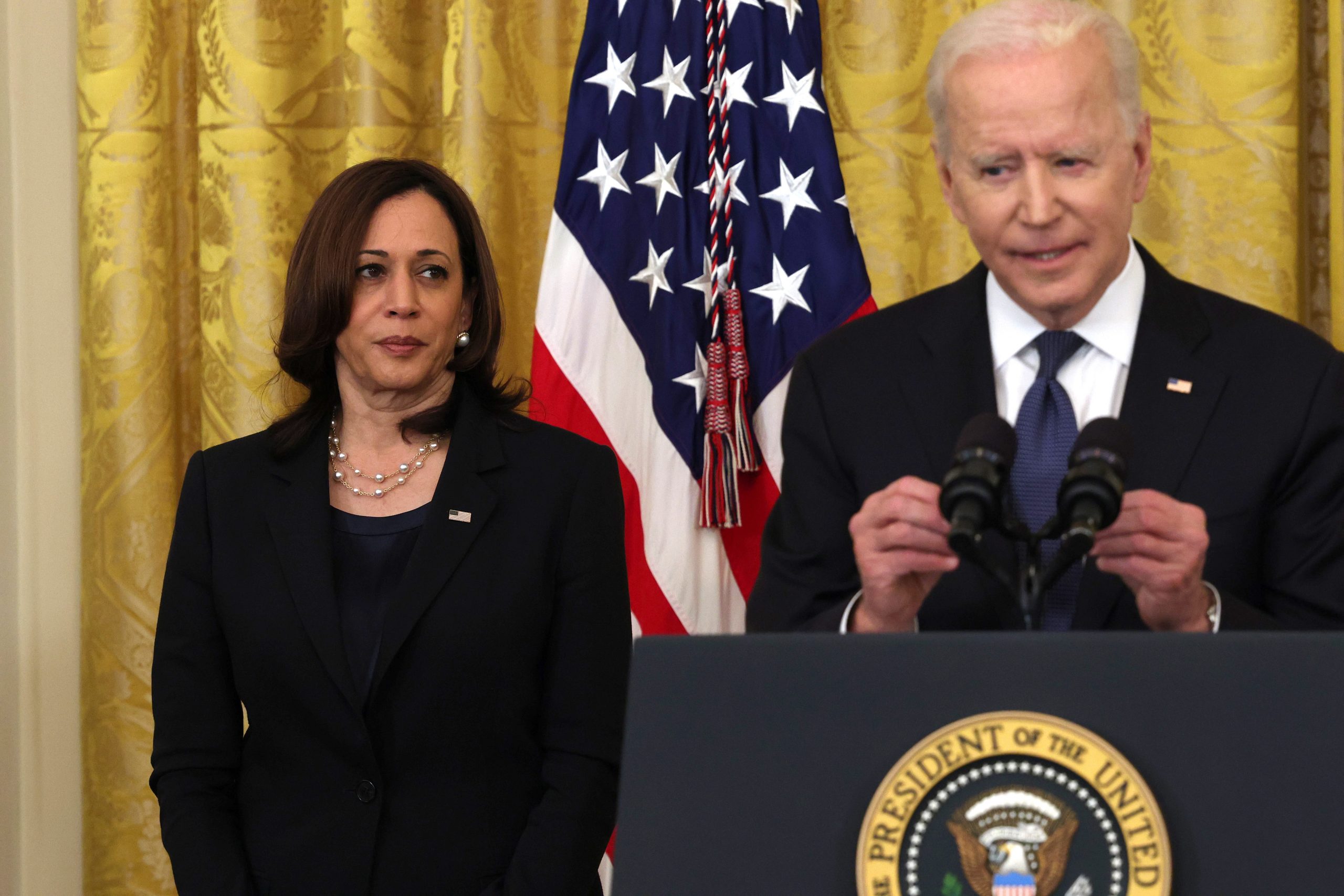 WASHINGTON, DC - MAY 20: Vice President Kamala Harris listens as U.S. President Joe Biden gives remarks, before a signing ceremony for the COVID-19 Hate Crimes Act in the East Room of the White House on May 20, 2021 in Washington, DC.  The legislation, drafted in response to the increased violence against the Asian American and Pacific Islander (AAPI) community during the Coronavirus pandemic, will create a new position in the Department of Justice to focus on the rise in hate crimes and provide resources to federal, state, and local jurisdictions to better report cases. (Photo by Anna Moneymaker/Getty Images).