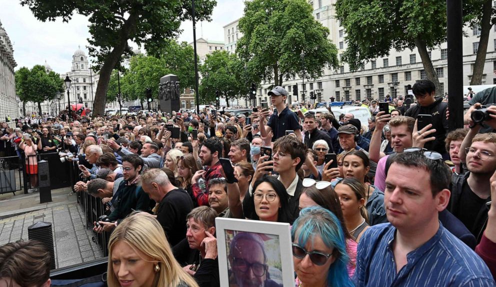 PHOTO: Members of the public wait outside the gates of Downing Street after Britain's Prime Minister Boris Johnson made a statement about his resignation in front of Number 10 in London, July 7, 2022.