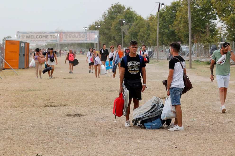 PHOTO: Young people leave the Medusa music festival after high winds caused part of a stage to collapse, in Cullera, near Valencia, Spain, on Aug. 13, 2022.