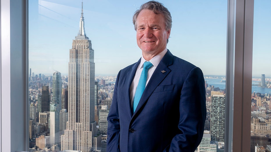 BofA CEO Brian Moynihan posing for a photo in a suit and blue tie