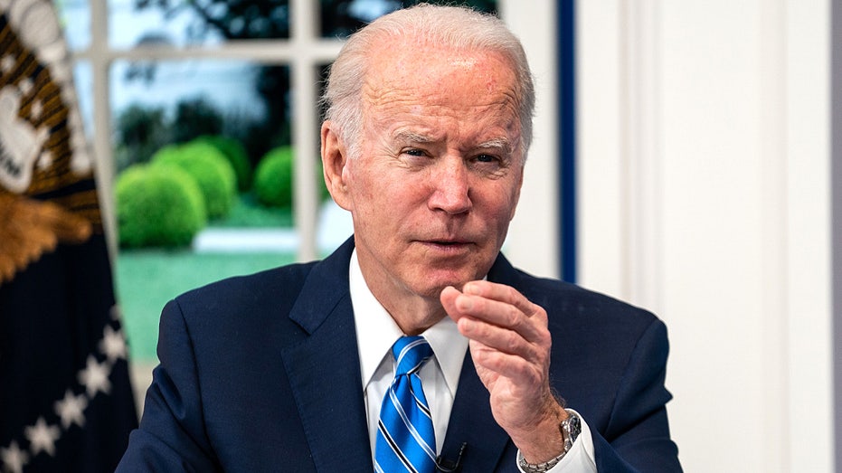 President Joe Biden reaching out with his hand while speaking