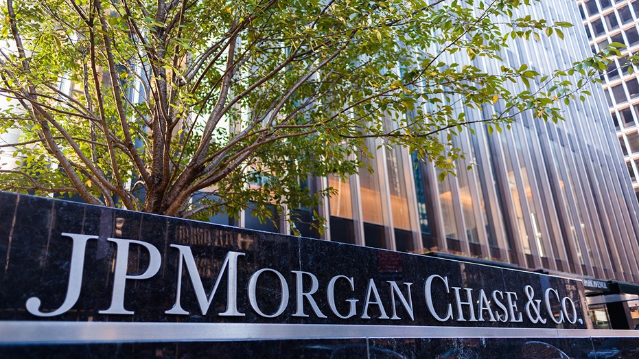 JP MORGAN CHASE logo with trees behind it