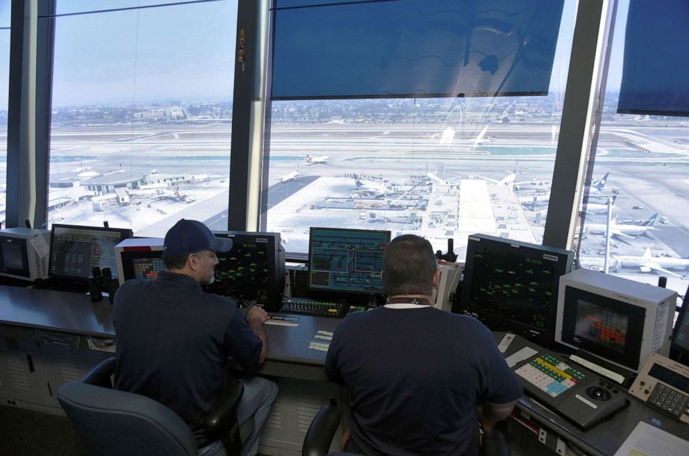 PHOTO: In this June 24, 2016, file photo, air traffic controllers talk with pilots inside the control tower at Los Angeles International Airport (LAX) in Los Angeles.