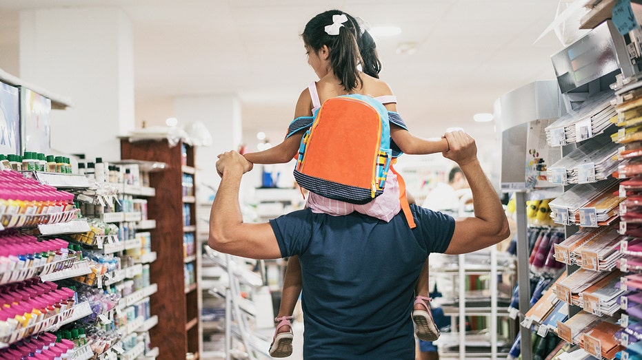 Dad carrying daughter on his shoulders