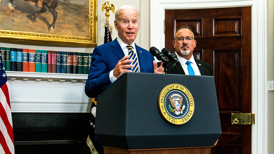 Biden stands at presidential podium