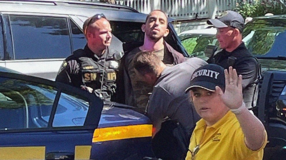 PHOTO: Law enforcement officers detain a person outside the Chautauqua Institution, in Chautauqua, N.Y., Aug. 12, 2022. Author Salman Rushdie was attacked by a man who rushed the stage, as Rushdie was about to give a lecture at the institute.