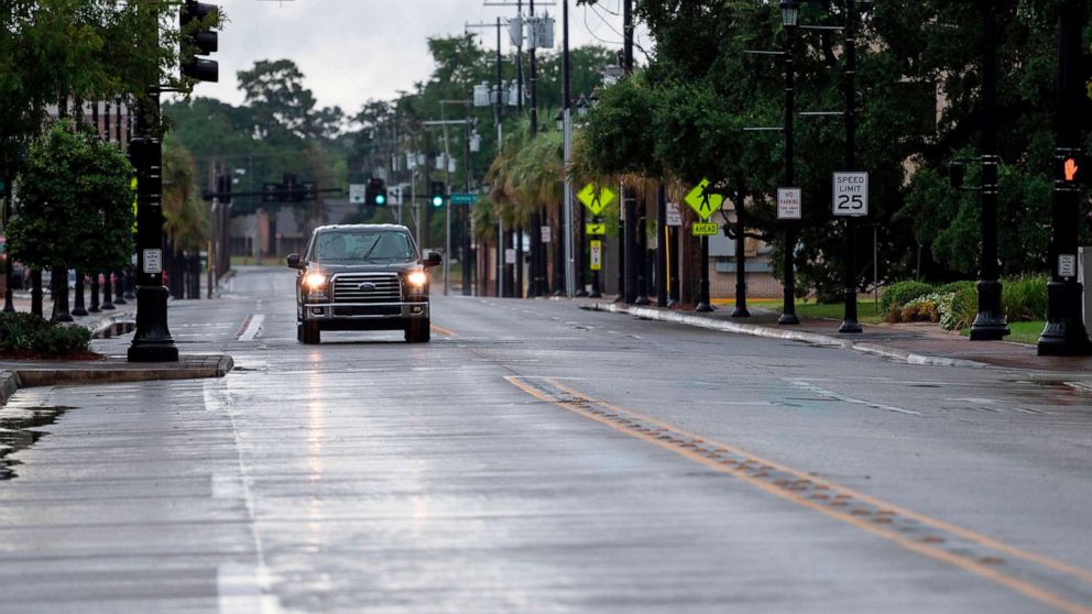 PHOTO: A car drives down an empty road in Lake Charles, La., Aug. 26, 2020. 