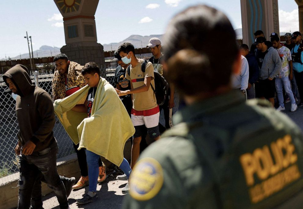 PHOTO:Migrants, mostly from Venezuela, walk after being detained by U.S. Border Patrol agents after crossing into the United States from Mexico to turn themselves in to request for asylum, in El Paso, Texas, Sept. 14, 2022. 