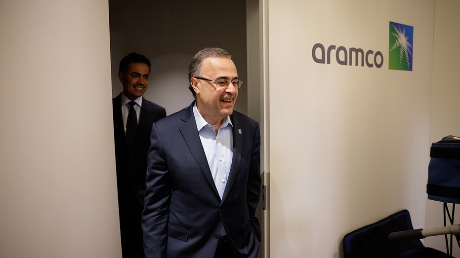 Amin Nasser next to the Aramco logo