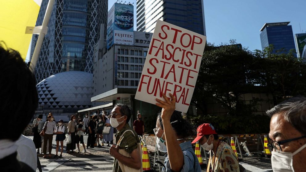 PHOTO: People hold signs and chant slogans during the march to protest against Shinzo Abe's State Funeral, on Sept. 25, 2022, in Tokyo, Japan