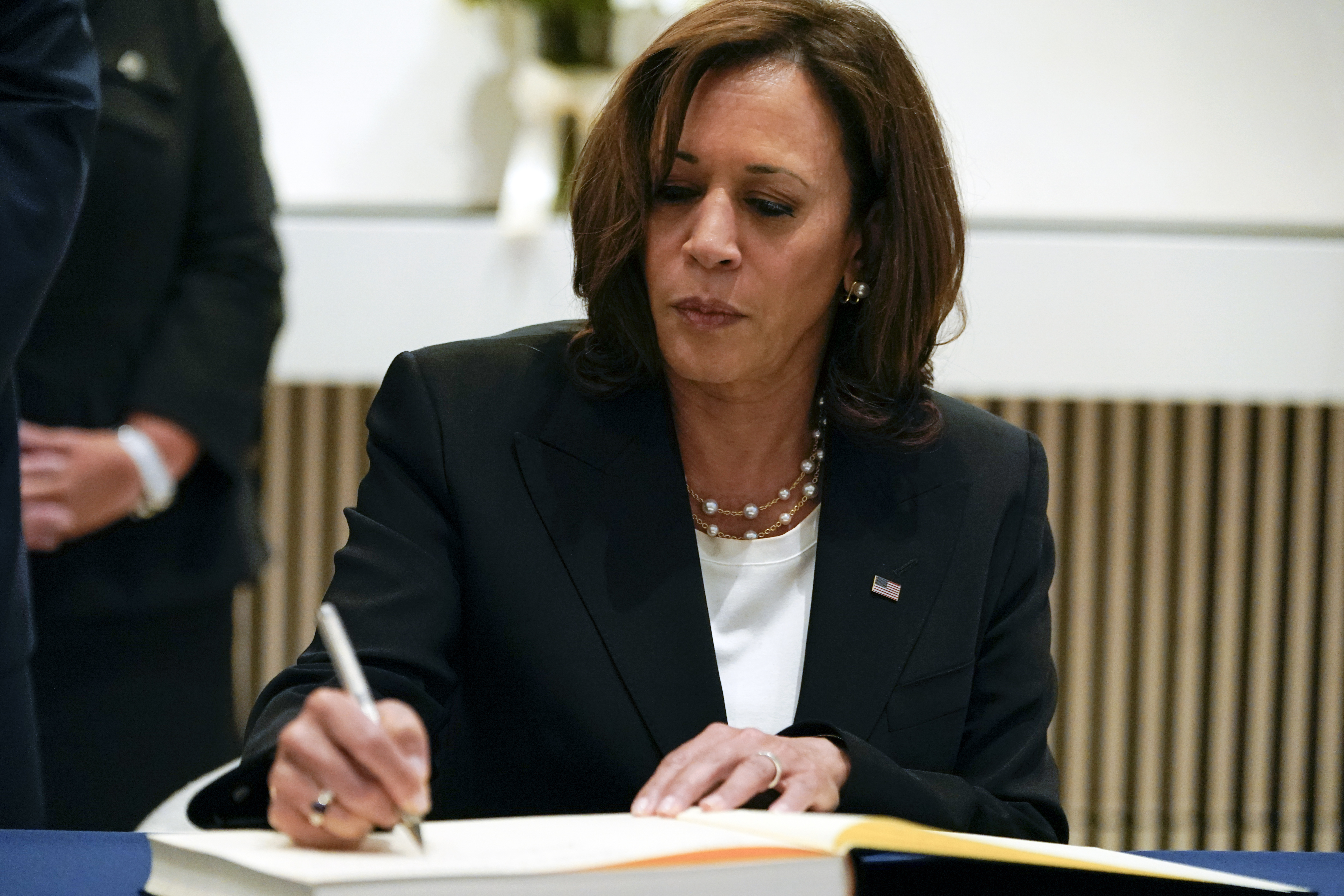 Vice President Kamala Harris signs a condolence book at the British Embassy in Washington, Friday, Sept. 9, 2022, for Queen Elizabeth II, Britain's longest-reigning monarch and a rock of stability across much of a turbulent century, who died Thursday, Sept. 8, after 70 years on the throne. She was 96. (AP Photo/Jacquelyn Martin)