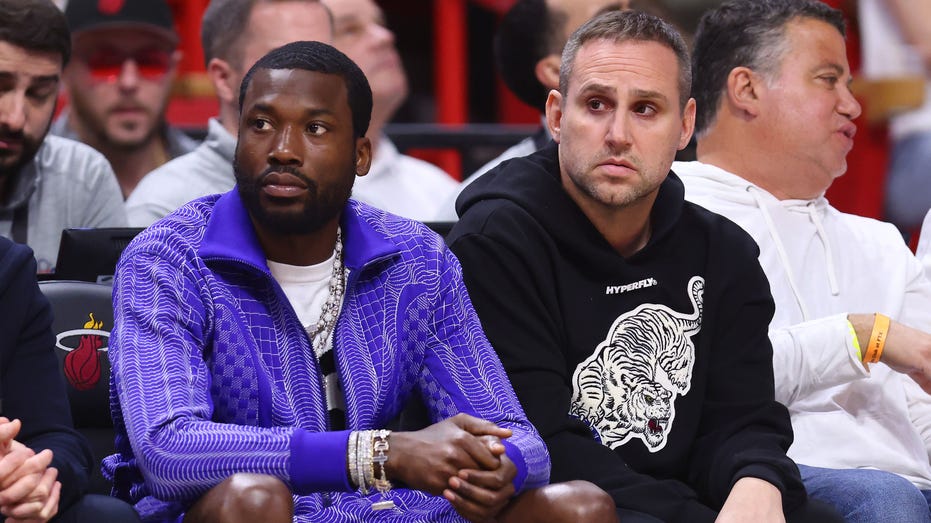 Meek Mill and Michael Rubin watching game