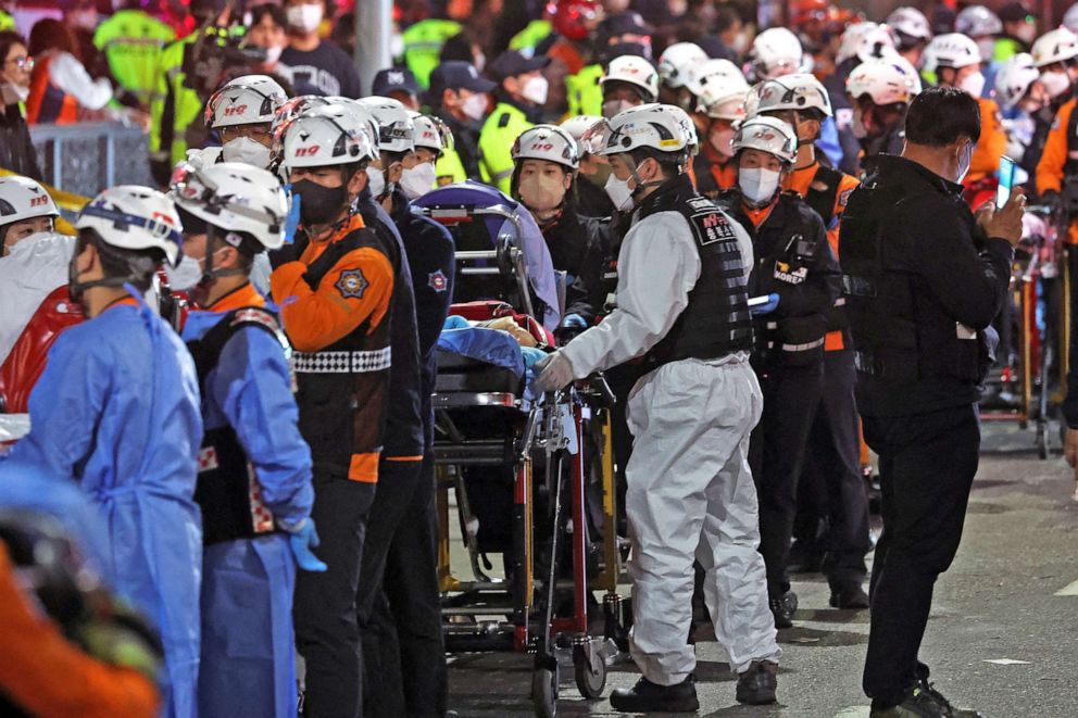 PHOTO: Rescue workers wait with stretchers at the scene where dozens of people were injured in a stampede during a Halloween festival in Seoul, South Korea, Oct. 30, 2022.