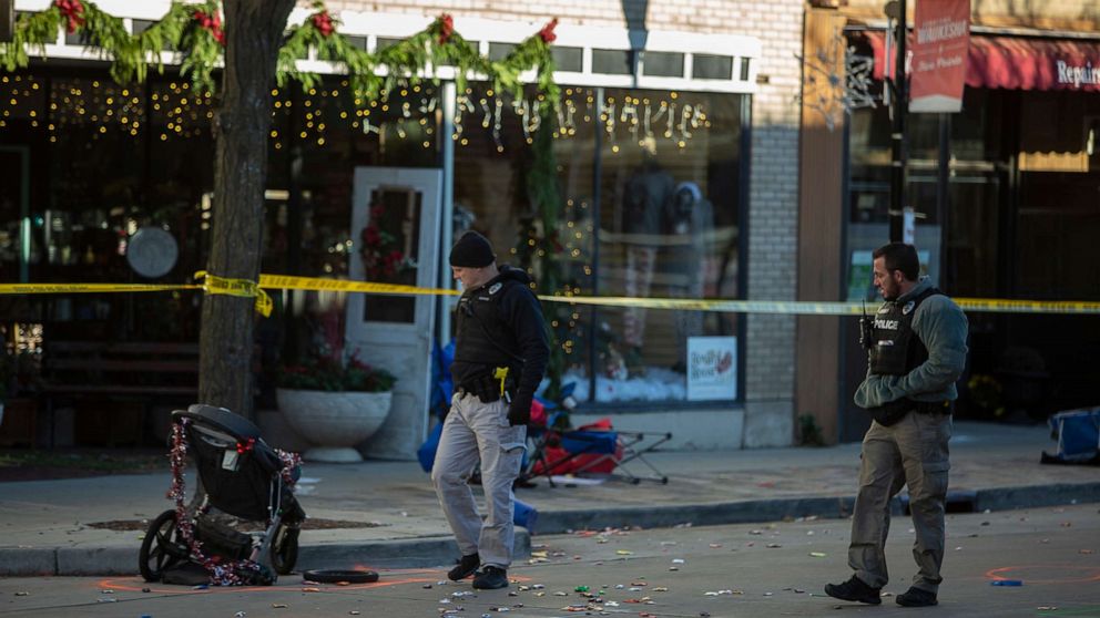 PHOTO: In this Nov. 22, 2021, file photo, police canvas debris left after a driver plowed into the Christmas parade on Main Street in downtown Waukesha, Wis.