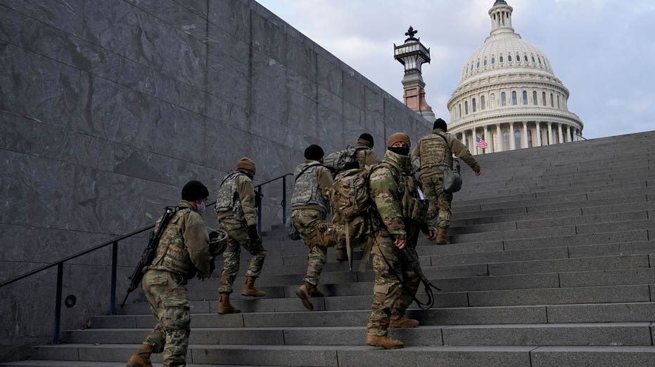 Soldiers walking up steps outside of the Capitol
