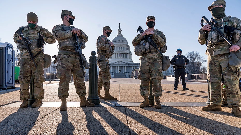 Soldiers standing guard in front of the Capitol