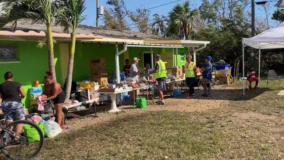 PHOTO: People collect food and supplies outside the Gladiolus Food Pantry in Harlem Heights, Fla., Oct. 1, 2022. The Gladiolus Food Pantry usually hands out supplies on Wednesdays, but had to suspend distribution due to Hurricane Ian.